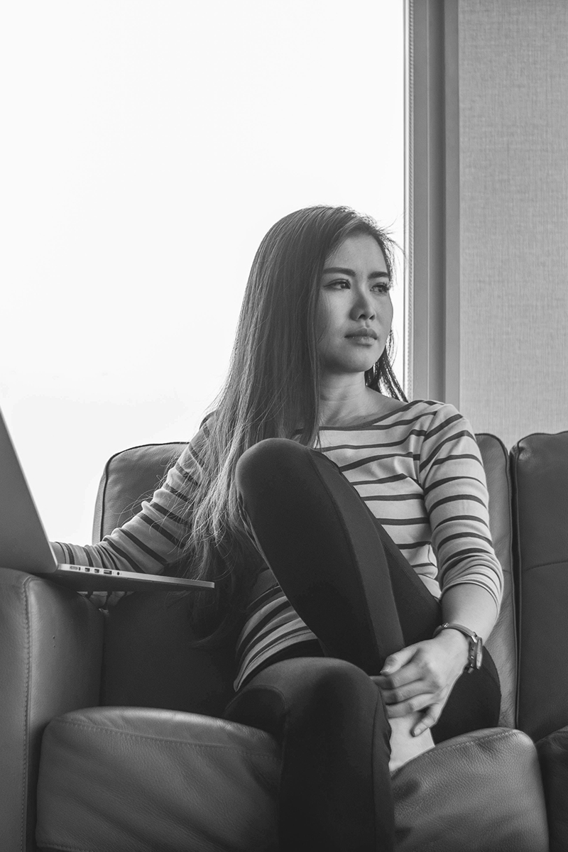 mimi-thian-U7lWyAV-aM8-unsplash copy A woman sitting and staring