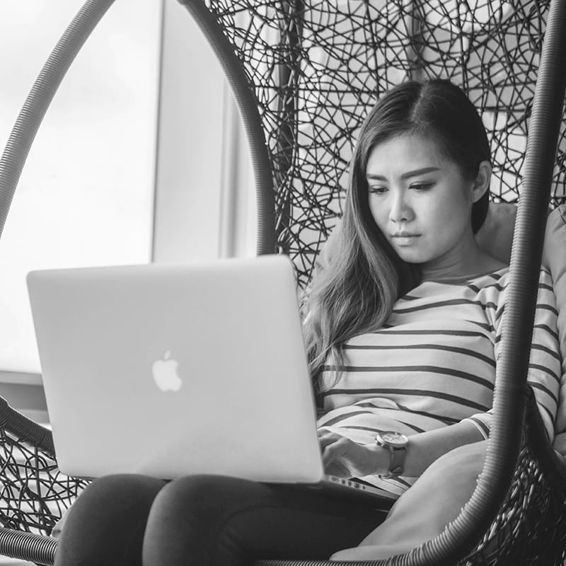 mimi-thian-i5cd_SlY8XY-unsplash copy A woman illustrating in a chair